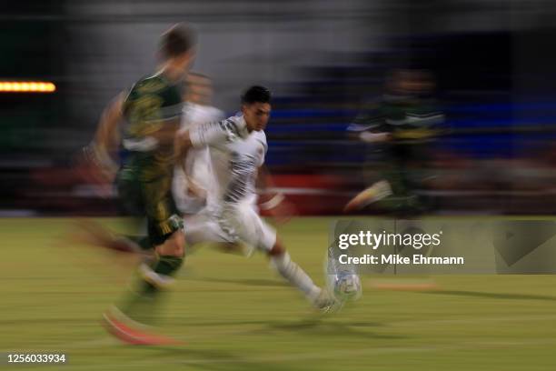 Cristian Pavon of Los Angeles Galaxy controls the ball against Dario Zuparic of Portland Timbers during a match between Los Angeles Galaxy and...