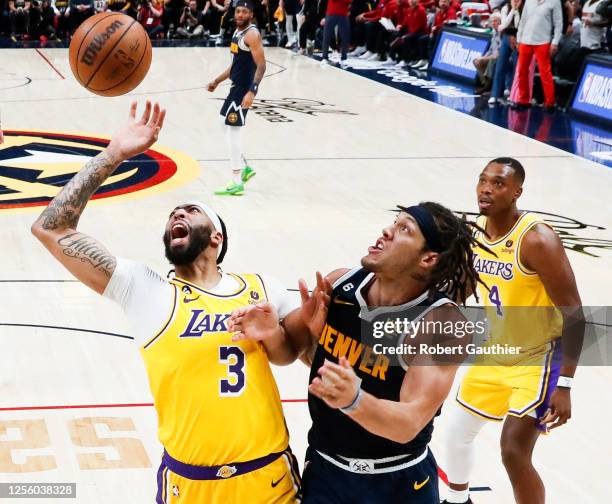 Los Angeles Lakers forward Anthony Davis, left and Denver Nuggets forward Aaron Gordon battle for the rebound during the second half of game two in...