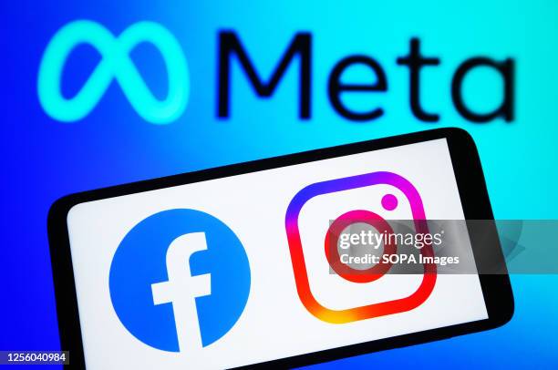 In this photo illustration, Facebook and Instagram logos are seen on a smartphone and Meta logo on a pc screen.