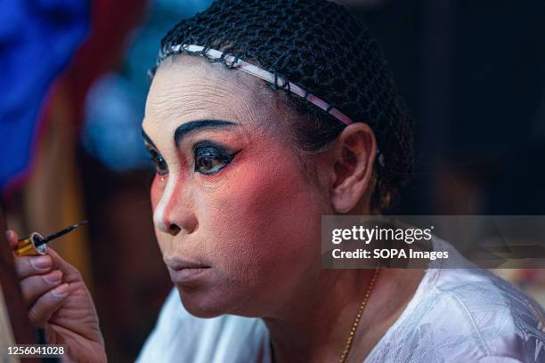 Chinese opera performer puts make-up in preparation for a performance at a temple in Bangkok. Chinese opera performer from the E Lai Heng Giah Tuang...
