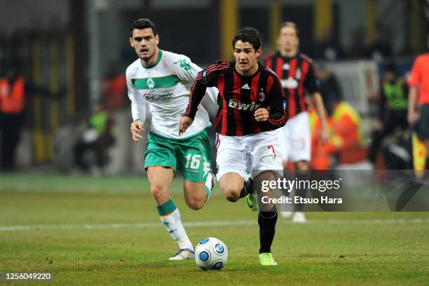 Alexandre Pato of AC Milan runs past Alexandros Tziolis of Werder Bremen during the UEFA Cup round of 32 second leg match between AC Milan and Werder...