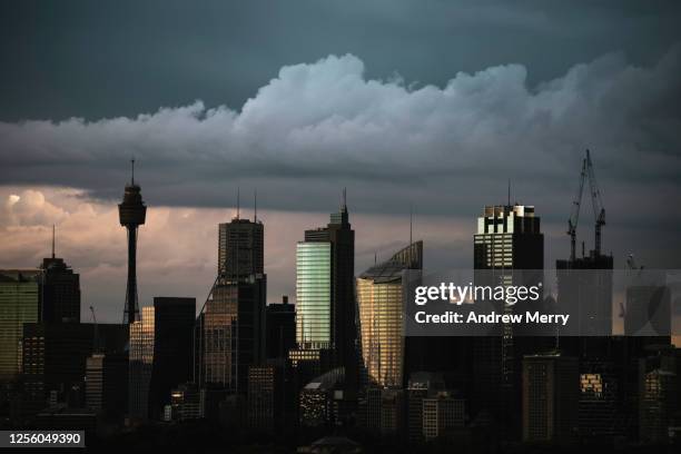 city skyline and storm clouds at dusk - sydney financial district stock pictures, royalty-free photos & images