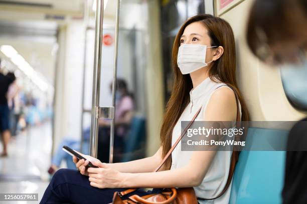 woman with mask in mrt - taipei mrt stock pictures, royalty-free photos & images