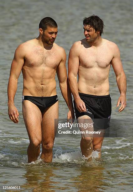 Chris Dawes and Leigh Brown of the Magpies comes out of the water during a Collingwood Magpies AFL recovery session at St Kilda Sea Baths on...