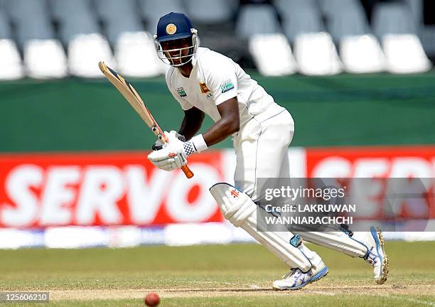 Sri Lankan batsman Angelo Mathews watches the ball after playing a stroke during the fourth day of the third and final Test match between Australia...