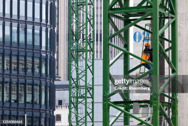 Crane operator descends from the crane cab on the Broadgate complex in the square mile financial district of the City of London, UK, on Friday, May...