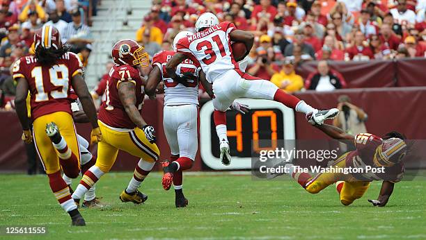 Arizona Cardinals defensive back Richard Marshall runs for yardage after intercepting a Rex Grossman pass in the first quarter as the Washington...