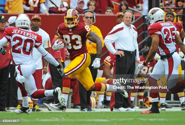 Washington Redskins tight end Fred Davis is pursued by Arizona Cardinals cornerback A.J. Jefferson while carrying the ball for a first down in the...