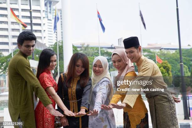 malaysian ethnic with traditional clothing at merdeka square kuala lumpur - malaysian people stock pictures, royalty-free photos & images