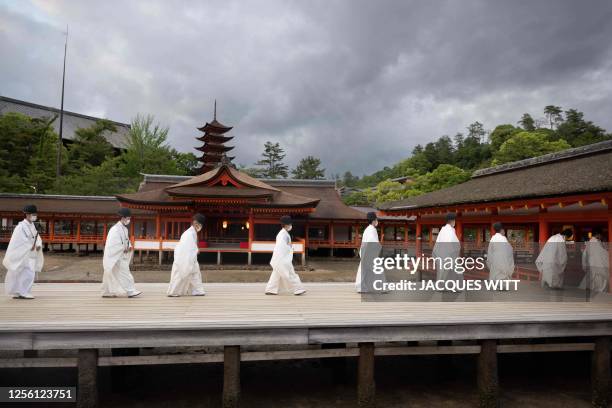 Minks walk in a line during a G7 leaders' visit to the Itsukushima Shrine in Miyajima Island as part of the G7 Leaders' Summit, on May 19, 2023.