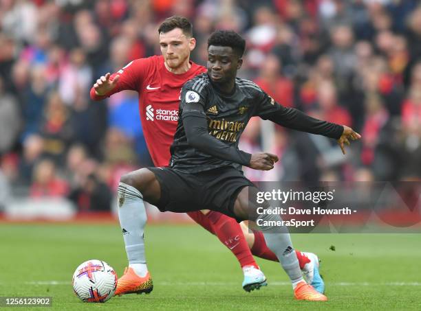 Liverpool's Andrew Robertson battles with Arsenal's Bukayo Saka during the Premier League match between Liverpool FC and Arsenal FC at Anfield on...