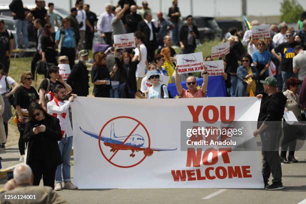 People protest as a Russian passenger plane lands in Tbilisi, Georgia, completing the first direct flight from Moscow to Tbilisi after a four-year...