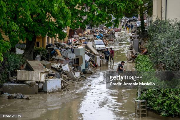 Residents clean their homes after heavy rains caused flooding across Italy's northern Emilia Romagna region, on May 19, 2023 in Faenza, Italy....