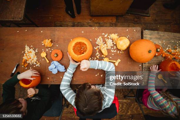 getting in the swing of halloween - pumpkin decorating stock pictures, royalty-free photos & images