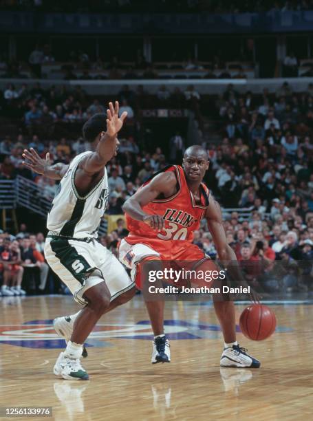 Mateen Cleaves, Guard for the Michigan State Spartans attempts to block Frank Williams of the University of Illinois Fighting Illini during their...
