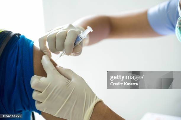 injecting vaccine. - influenza vaccination stock pictures, royalty-free photos & images