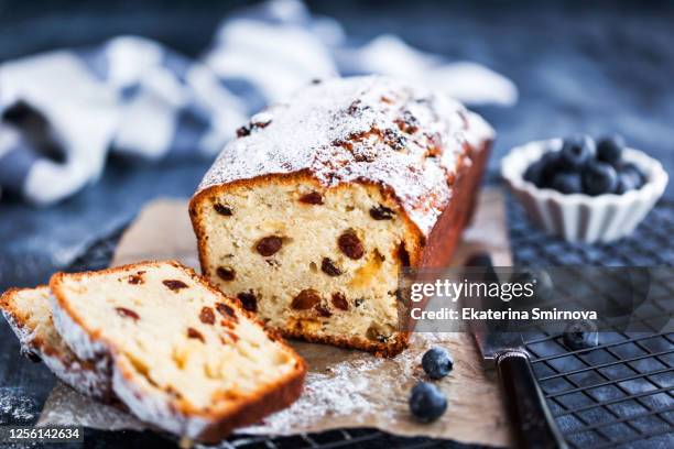 delicious homemade cottage cheese and raisins loaf cake on blue background, close up - loaf of bread bildbanksfoton och bilder