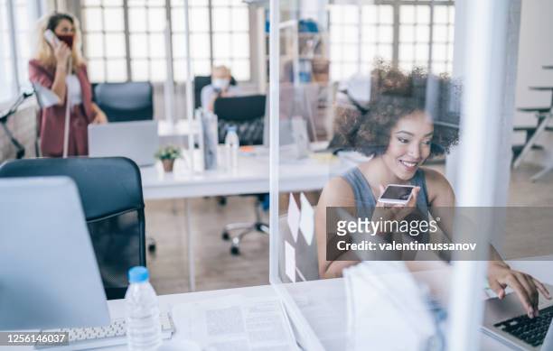 businesswoman at work talking on phone, during covid-19 - bank office clerks stock pictures, royalty-free photos & images