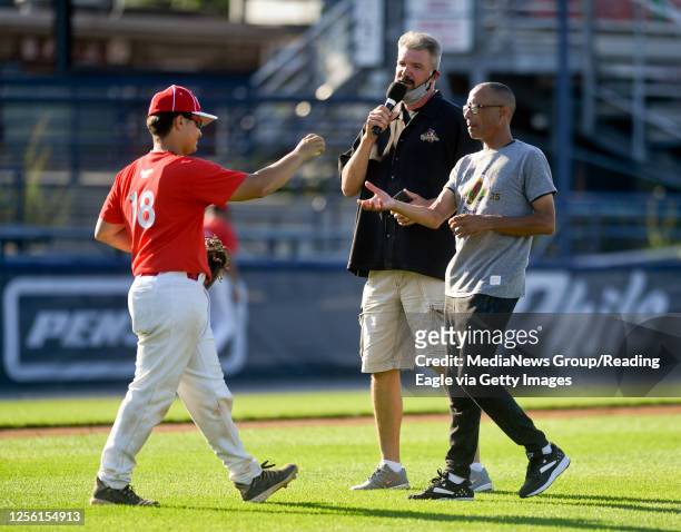 Reading, PA Angel Velez, a Reading High player playing or the Red team, hands Greg Edge, the 2020 King of Baseballtown and a former Reading Phillies...