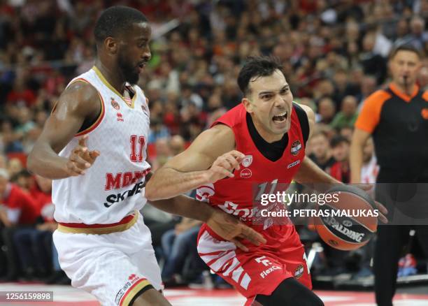 Olympiacos' Kostas Sloukas vies for the ball with AS Monaco' Alpha Diallo during the EuroLeague Final Four Semi-final match between Olympiacos...