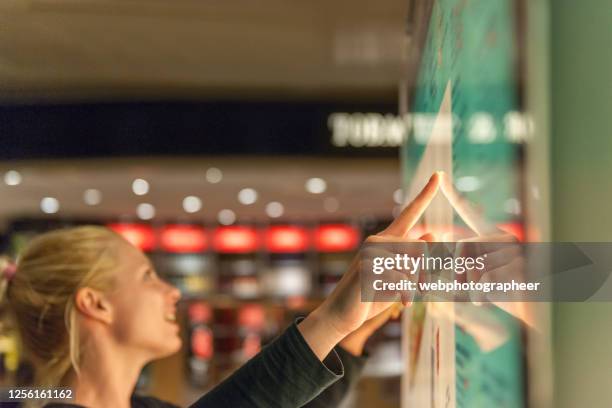 using touch screen to find informations - shopping centre screen stock pictures, royalty-free photos & images