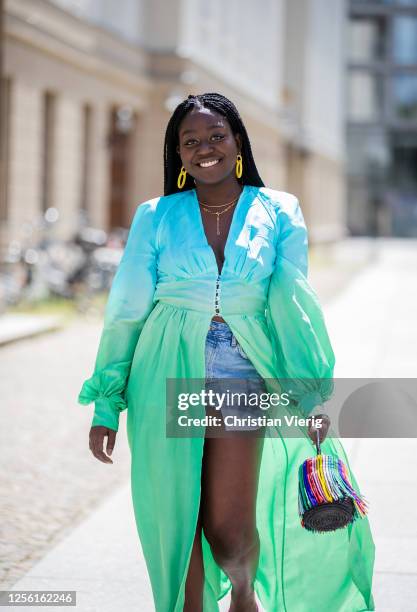 Lois Opoku is seen wearing kimono The Attico, Zara denim shorts, Balenciaga heels, Sensi Studio bag, necklace and earrings Ariane Ernst on July 14,...