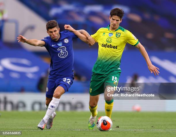 Christian Pulisic of Chelsea is challenged by Timm Klose of Norwich City during the Premier League match between Chelsea FC and Norwich City at...