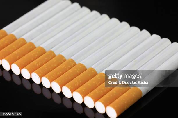 row of smoking cigarettes on a black background - blank cigarette box stock pictures, royalty-free photos & images