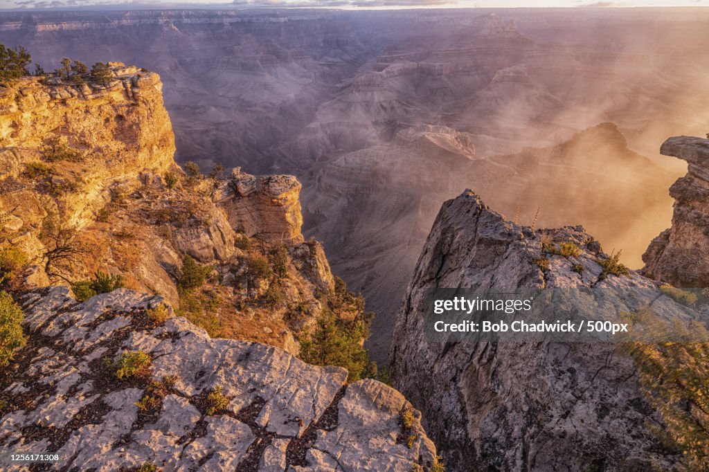 Foggy cliffs at sunrise viewed from Yavapai Point in Grand Canyon, Arizona, USA
