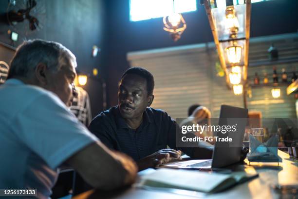 colleagues doing a business meeting in a pub - busy pub stock pictures, royalty-free photos & images