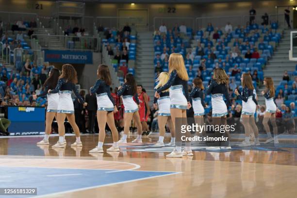cheerleaders performing in court - cheerleader photos stock pictures, royalty-free photos & images