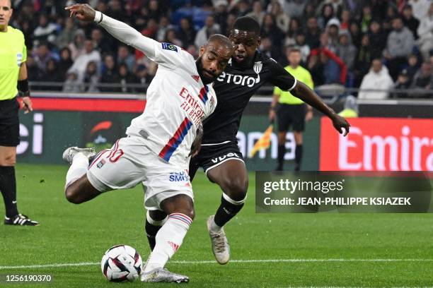 Lyon's French forward Alexandre Lacazette fights for the ball with Monaco's Belgian midfielder Eliot Matazo during the French L1 football match...