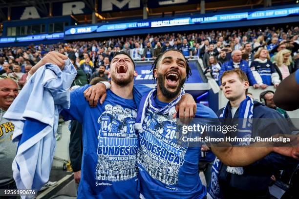 Keanan Bennetts of SV Darmstadt 98 celebrates their promotion to the Bundesliga with a team mate after the Second Bundesliga match between SV...