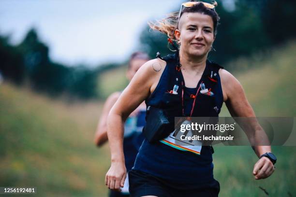 two female runners racing in the nature - half marathon stock pictures, royalty-free photos & images