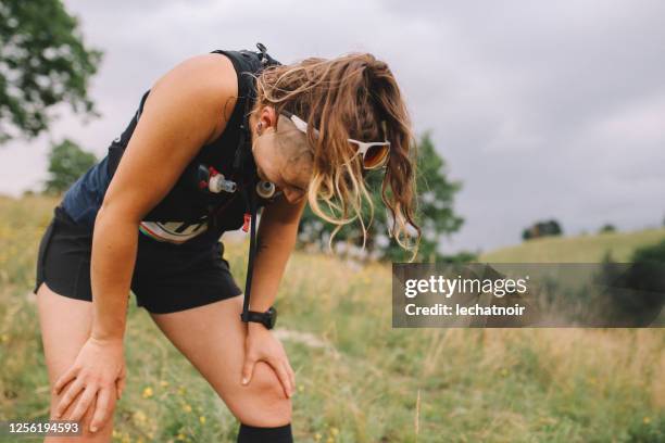 female runner exhausted after a race - marathon stock pictures, royalty-free photos & images