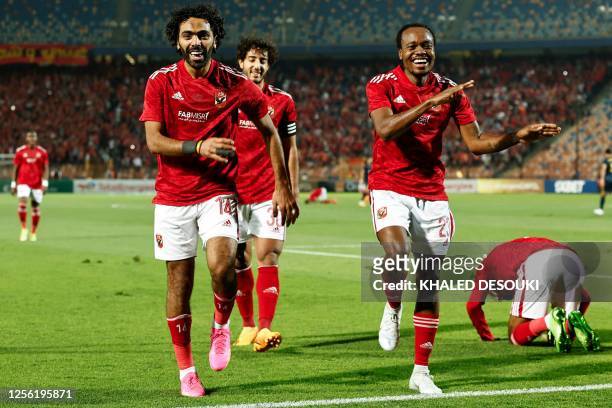 Ahly's Egyptian midfielder Hussein el-Shahat celebrates with teammates after scoring his team's first goal during the CAF Champions League semi-final...