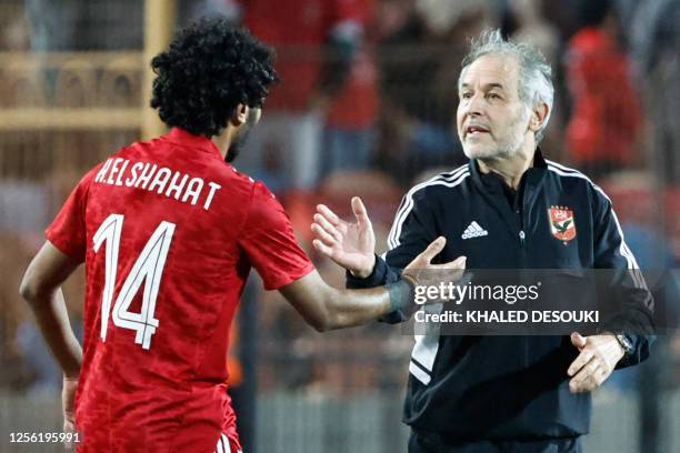 Ahly's Egyptian midfielder Hussein el-Shahat celebrates with Ahly's Swiss coach Marcel Koller after scoring the first goal during the CAF Champions...