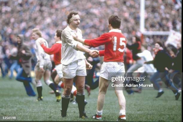 Bill Beaumont of England shakes hands with his opposing number JPR Williams of Wales at the end of the Five Nations match at Cardiff Arms Park in...