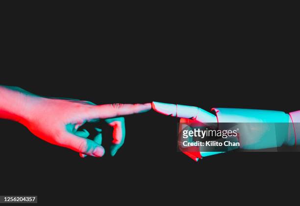 human hand reaching for robotic hand - human finger stock pictures, royalty-free photos & images