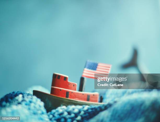 little tug boat battling stormy seas - toy animal stock pictures, royalty-free photos & images