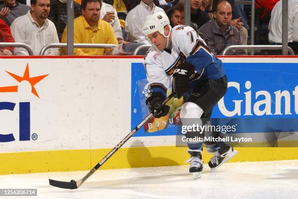 Adam Oates of the Washington Capitals skates with the puck during a NHL hockey game against the Boston Bruins at MCI Center on December 14, 2001 in...