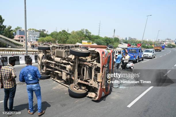 Truck overturned due to bursting of its rear tire on the Rajiv Chowk flyover of National Highway-48 causing traffic congestion, driver and conductor...