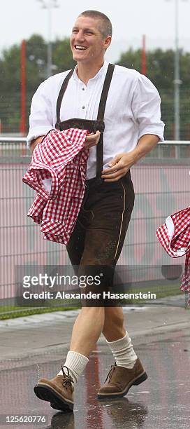Bastian Schweinsteiger of FC Bayern Muenchen arrives for the Paulaner photocall at Bayern Muenchen's trainings ground Saebener Strasse on September...