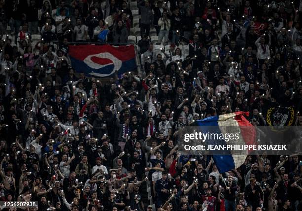 Lyon's supporters cheer during the French L1 football match between Olympique Lyonnais and AS Monaco at The Groupama Stadium in Decines-Charpieu,...
