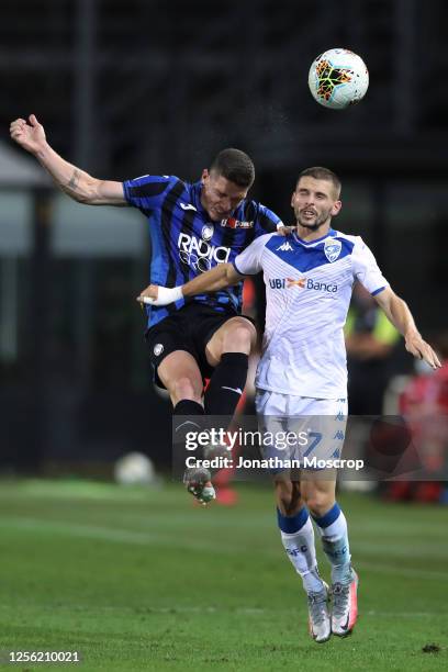 Robin Gosens of Atalanta competes for a header against Nikolas Spalek of Brescia Calcio during the Serie A match between Atalanta BC and Brescia...