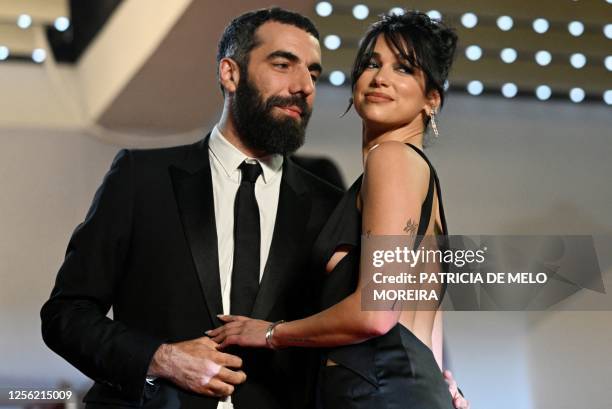 French director Romain Gavras and British singer and model Dua Lipa arrive for the screening of the film "Omar la Fraise" during the 76th edition of...
