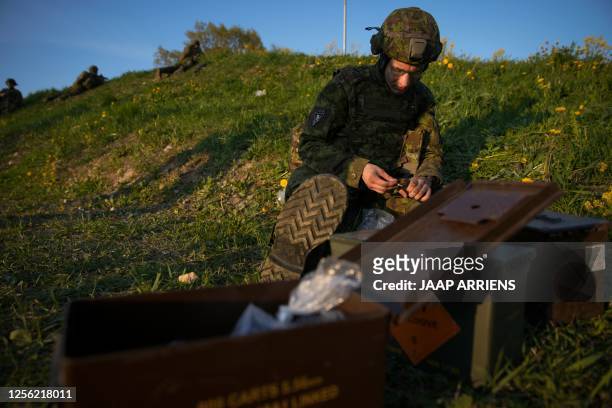 Member of the Estonian Defence Forces fills a magazine with bullets during the Spring Storm exercises of the NATO Enhanced Forward Presence force in...