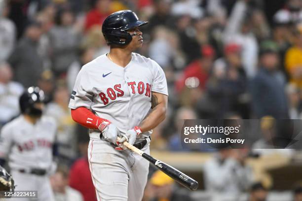 Rafael Devers of the Boston Red Sox hits a three-run home run during the third inning of a baseball game against the San Diego Padres at Petco Park...