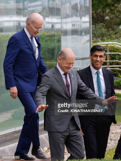 President Joe Biden, Germany's Chancellor Olaf Scholz, and Britain's Prime Minister Rishi Sunak walk to participate in a family photo with G7 leaders...