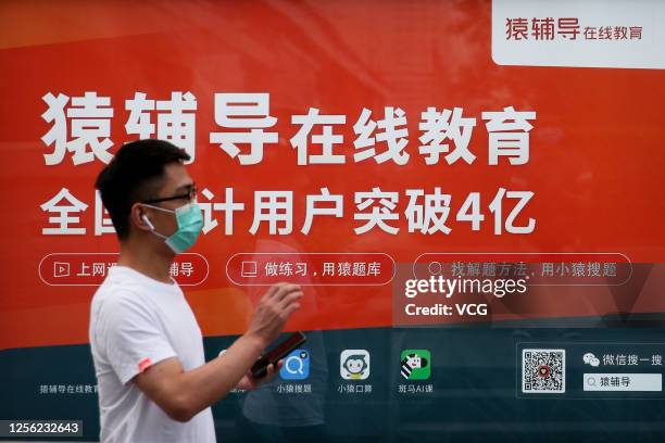 Man walks past an advertisement for Chinese online education startup Yuanfudao on June 23, 2020 in Beijing, China.